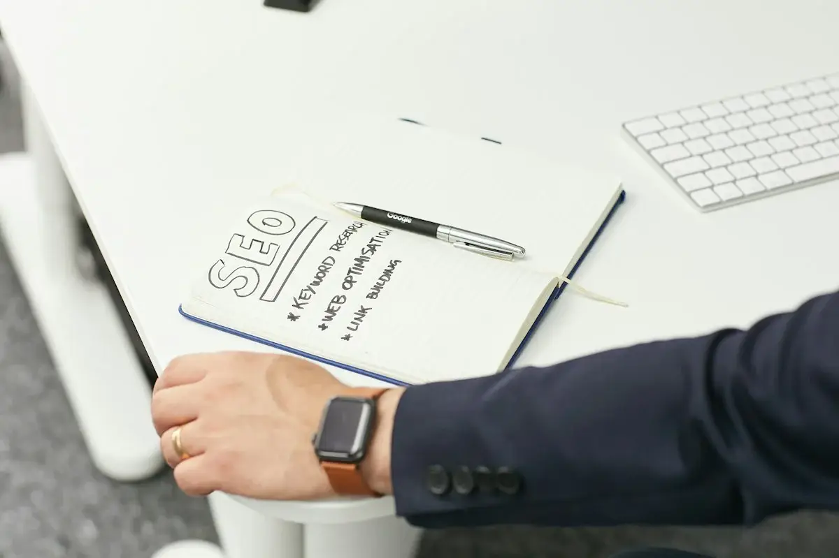 Person writing a content plan on paper