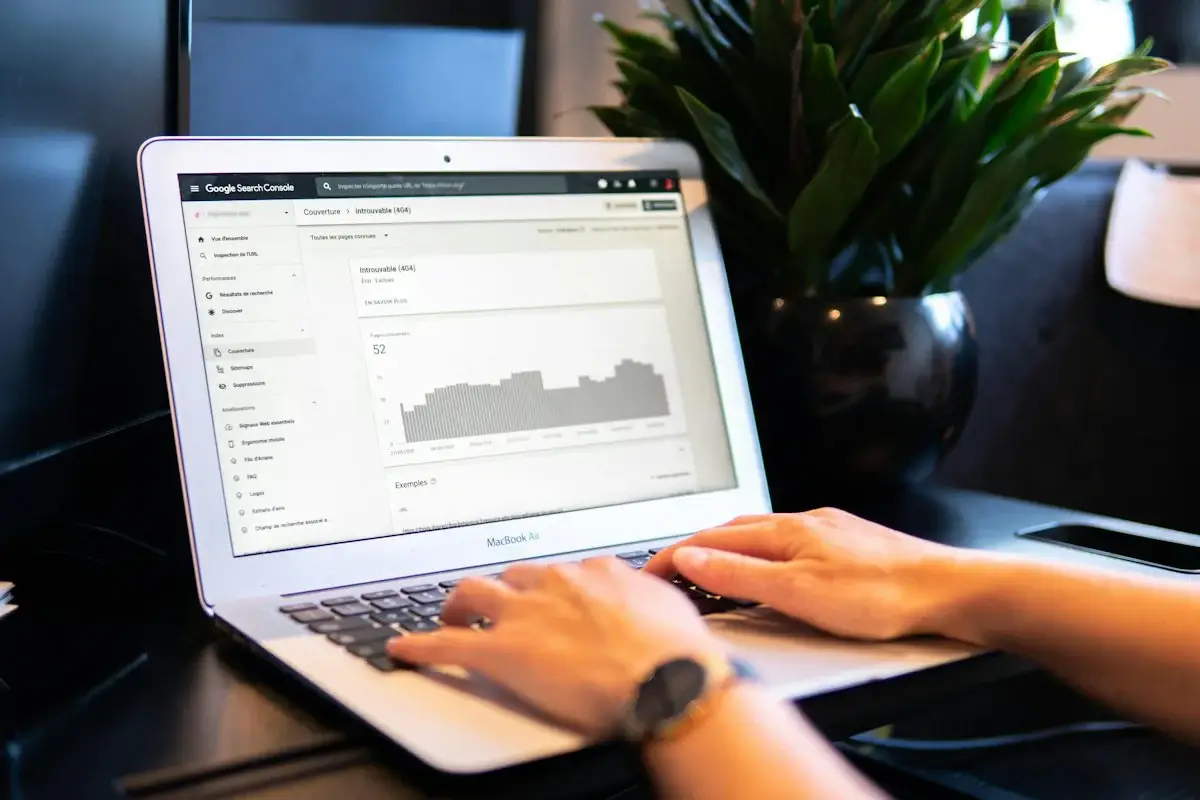Person comparing options on a laptop at a wooden table