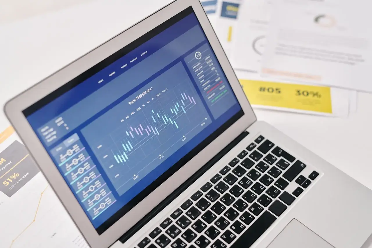 SEO specialist near me analysing ranking charts and reports on a laptop